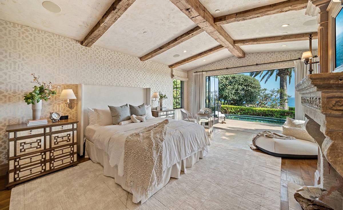 The primary suite at 15 Montage Way, with multiple walk-in closets, its own stone fireplace and sitting area with direct backyard access.