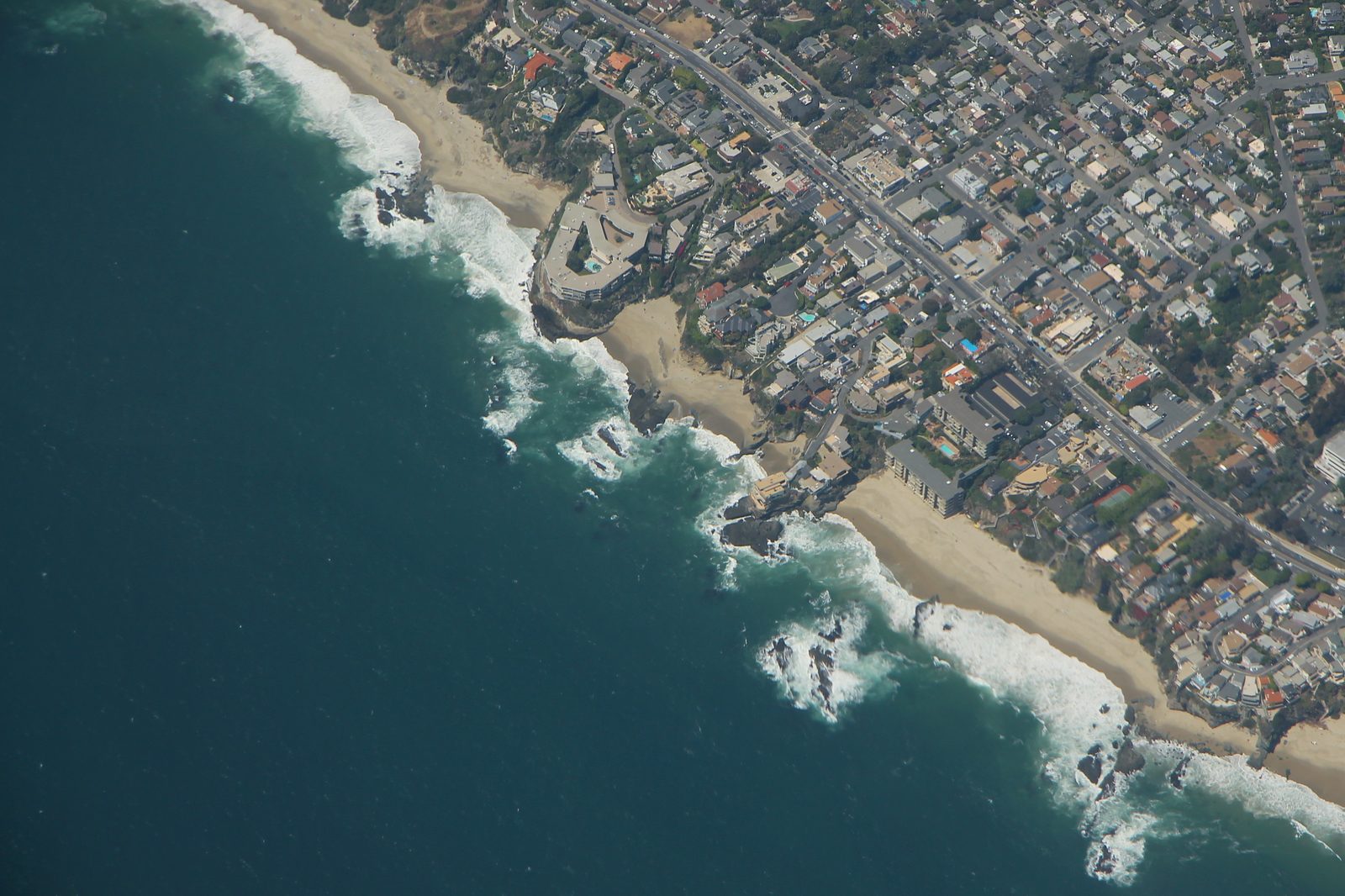 An aerial view of the rocky Table Rock headland, where surf pounds the bluffs along Laguna's south coast.
