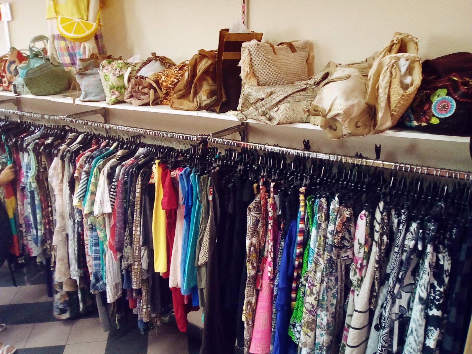 Racks of clothing in a secondhand shop.