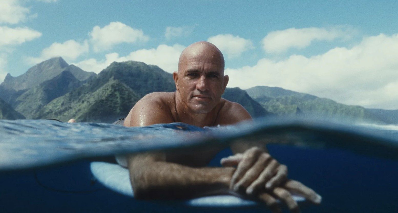 Kelly Slater in the water at Teahupo'o, in a still from Kelly + Tahiti. The film about his return to competition at the 2026 Outerknown Tahiti Pro screens on the festival's opening night.