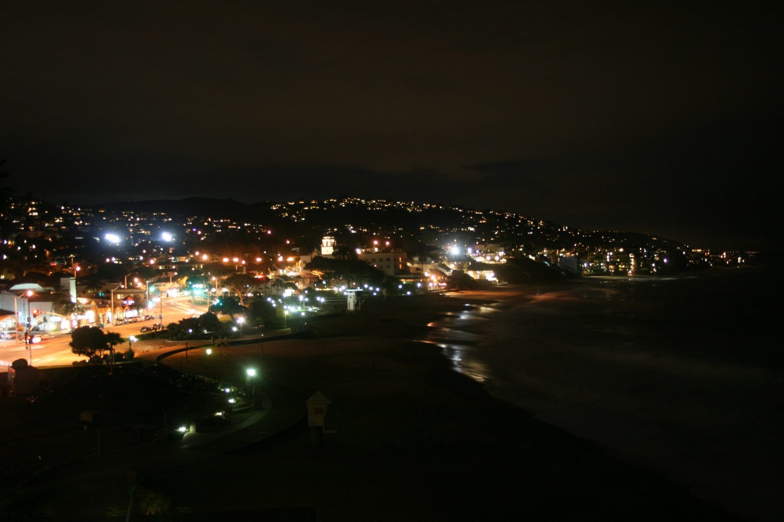 Downtown Laguna Beach and Main Beach after dark, seen from Heisler Park. Forest Avenue and Glenneyre Street close nightly from 9:30 p.m. to 9 a.m. for crosswalk work.