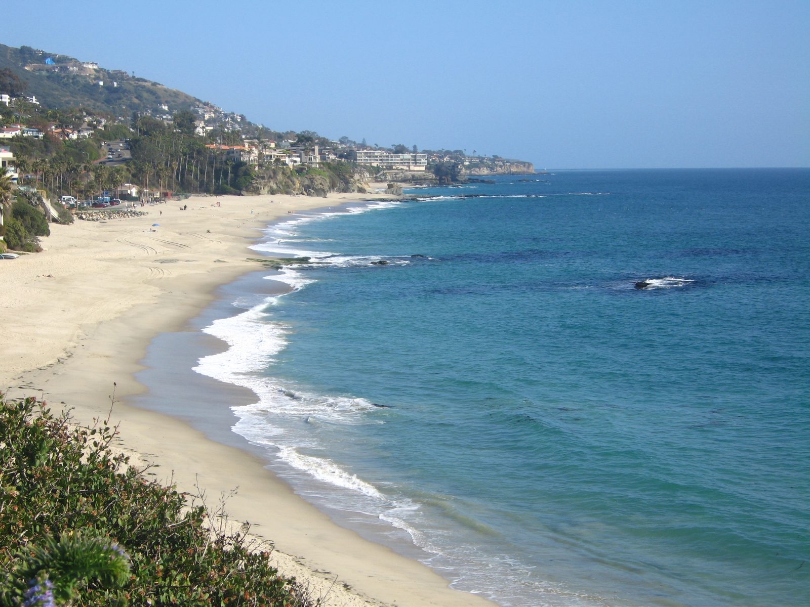 Aliso Beach under clear skies; overnight lows in the 70s mean little relief after sunset.