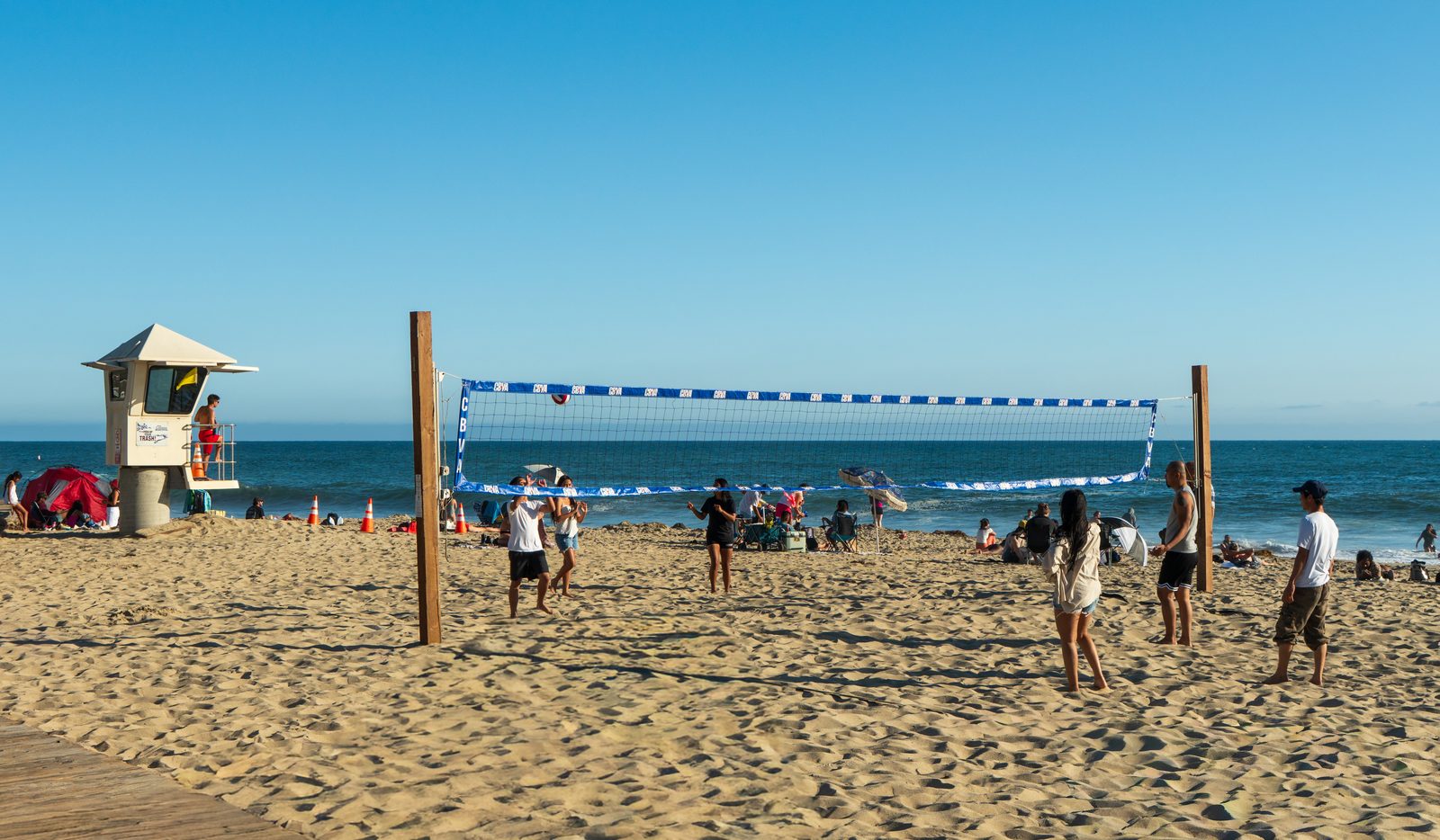 A volleyball game on Main Beach, part of the visitor economy the hotel tax would have drawn on.