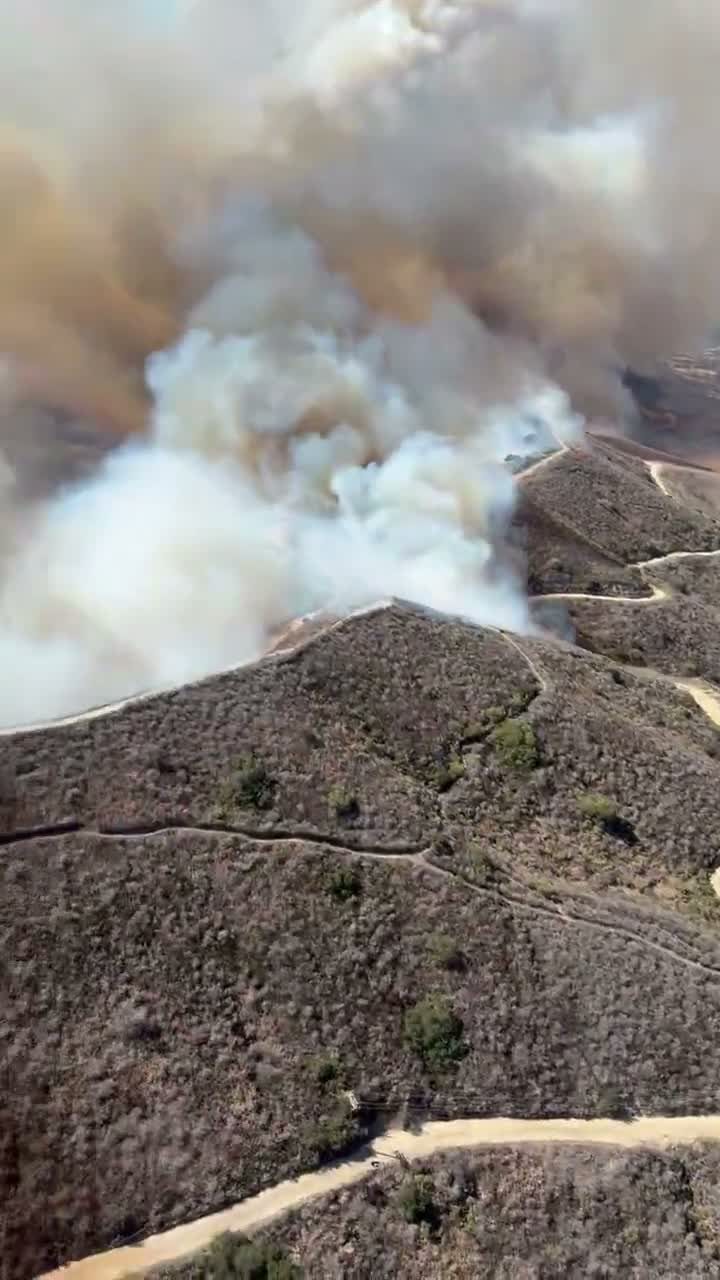 Smoke pours from the Norte Fire on Friday in an overhead view from a firefighting helicopter. The fire started at 11:33 a.m. on Friday near Portico Del Norte and Eminencia Del Norte in San Clemente.
