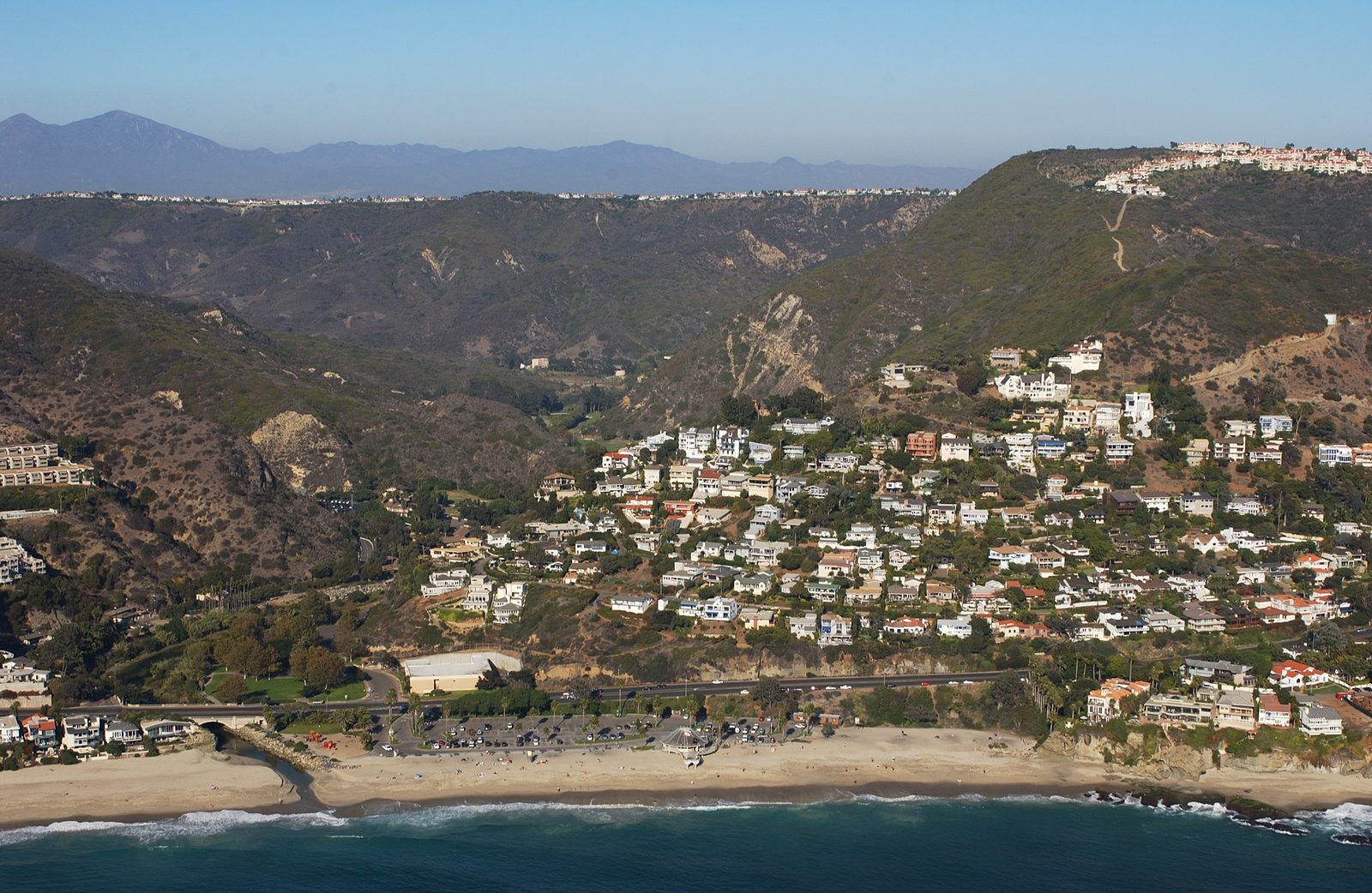 Homes crowd the canyon mouth at Aliso Beach, the wildland-urban interface at the heart of the Zone Zero debate.