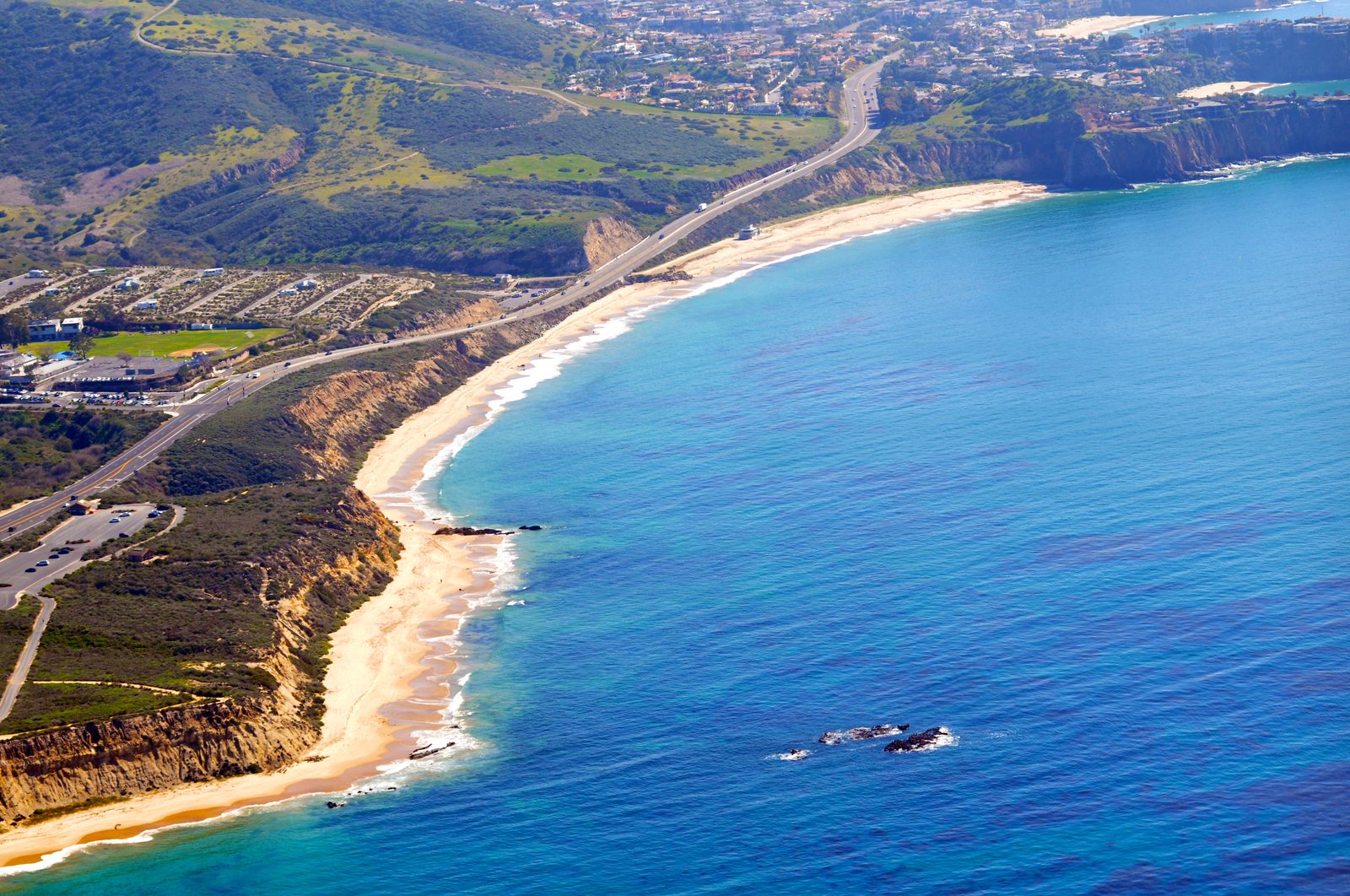 The beach and historic cottages at Crystal Cove State Park. The crack in the slope above Moro Beach measures about 360 feet long and 2 feet wide, according to Caltrans.