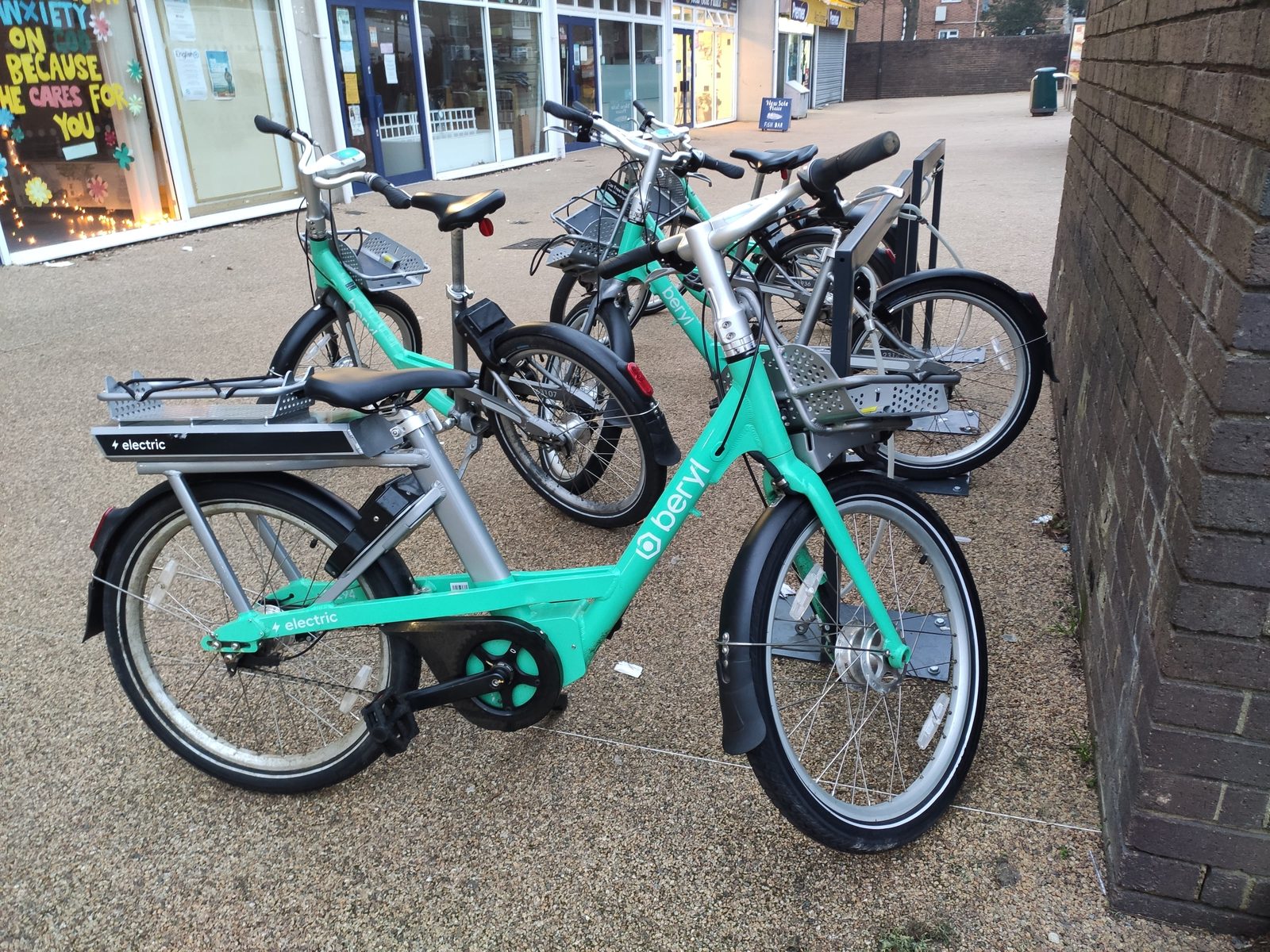 Electric hire bikes at a docking station; e-bikes of this class are the focus of the county buyback Laguna police have joined.