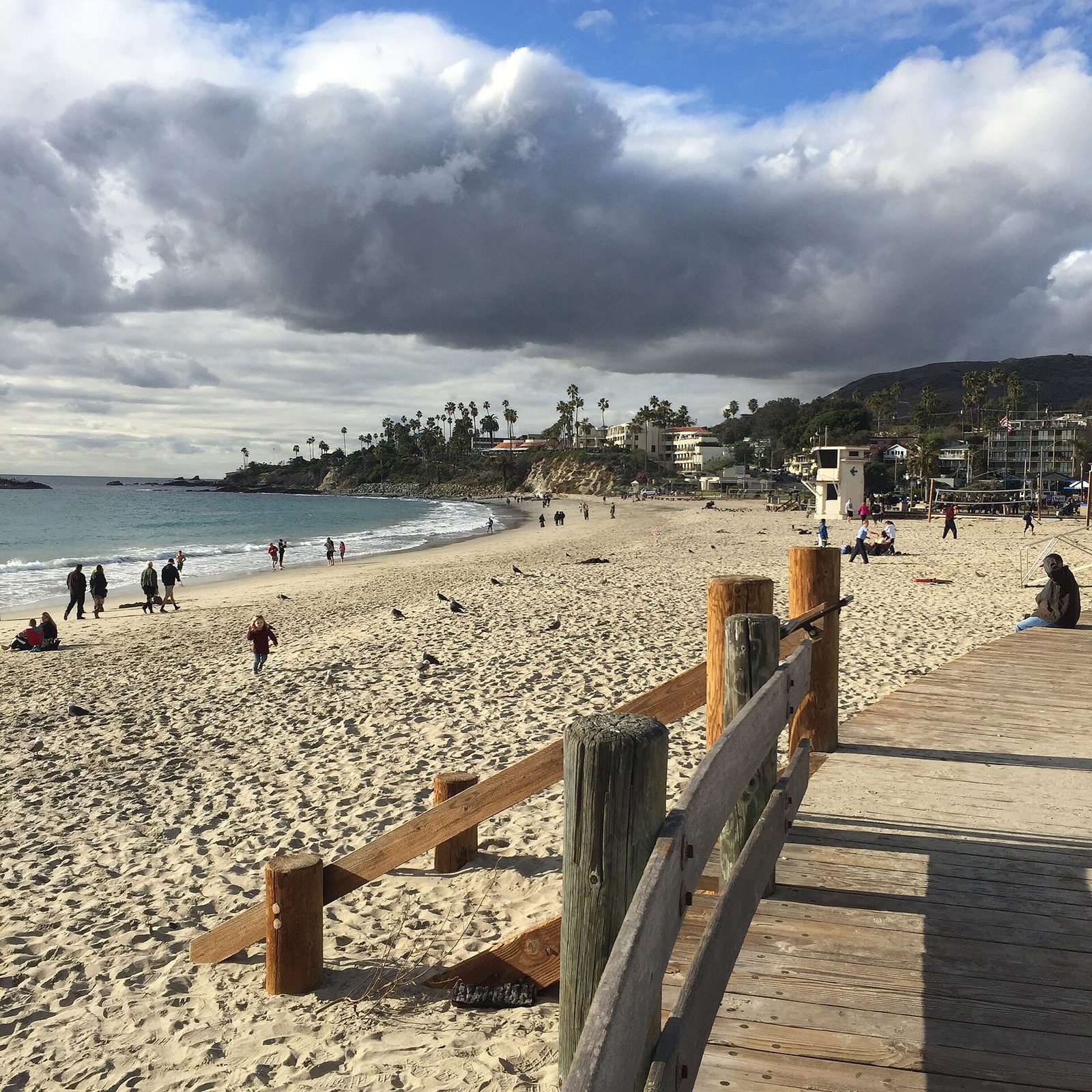 The boardwalk at Main Beach in Laguna Beach under heavy clouds. The newly built sand berms held through Sunday's 9:45 a.m. high tide.