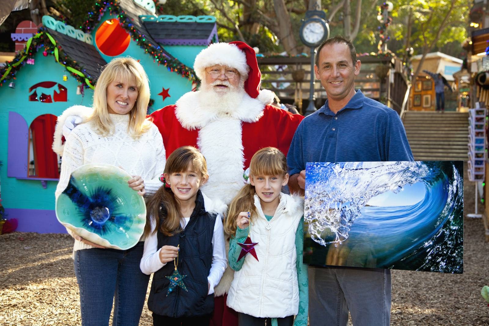 A family poses with Santa Claus at Winter Fantasy, the Sawdust Art Festival's holiday show.